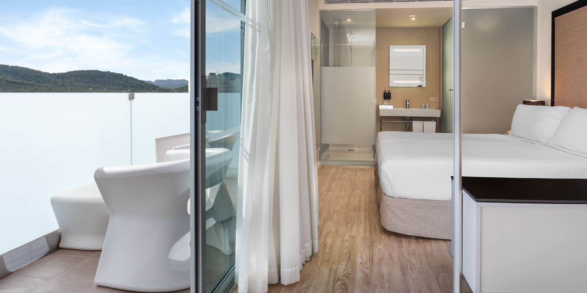 a room with a bed and a glass door