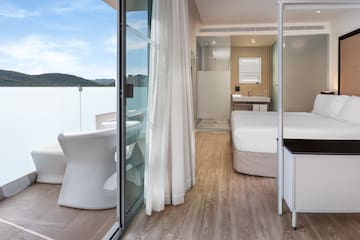 a room with a bed and a glass door