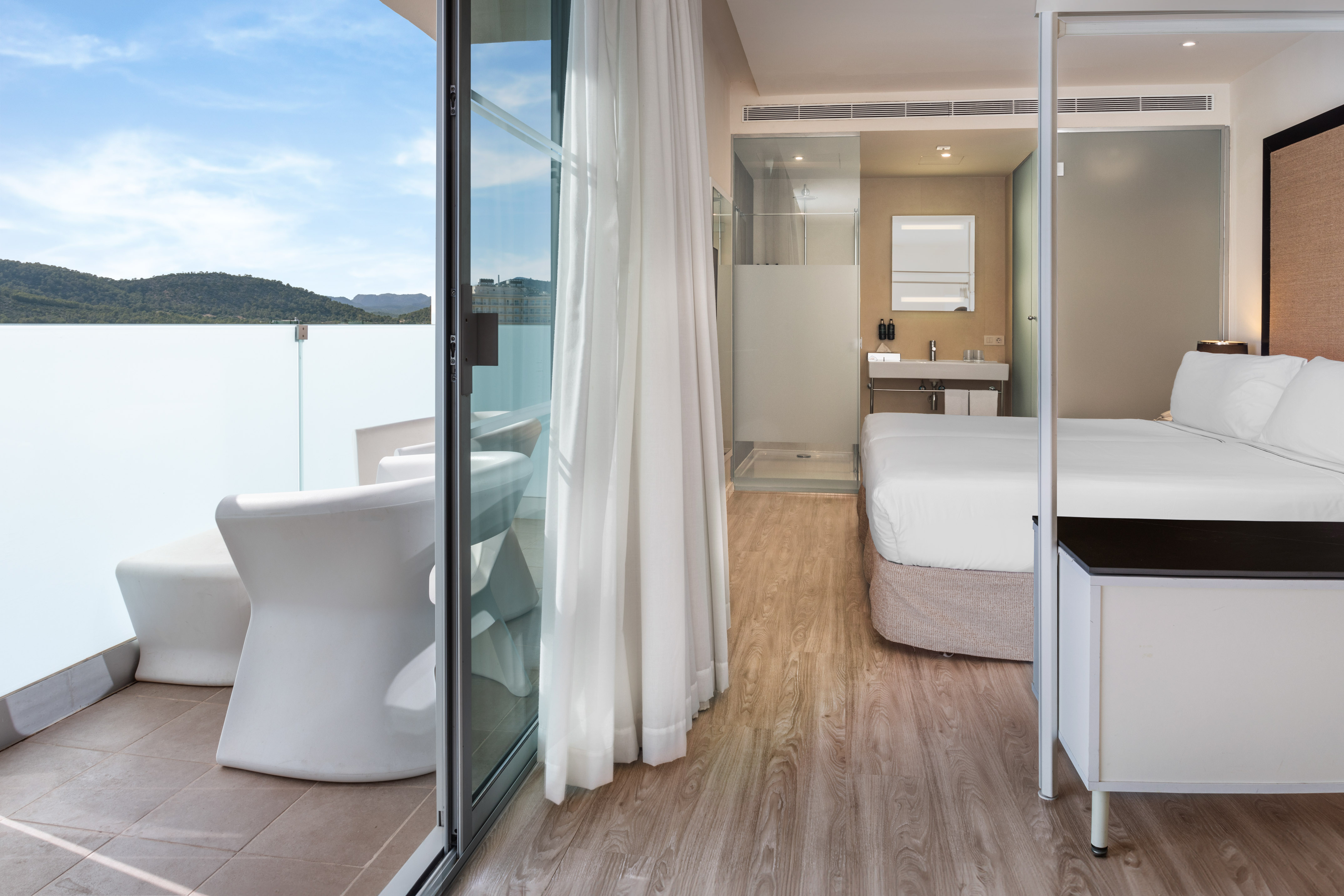 a room with a bed and a glass door