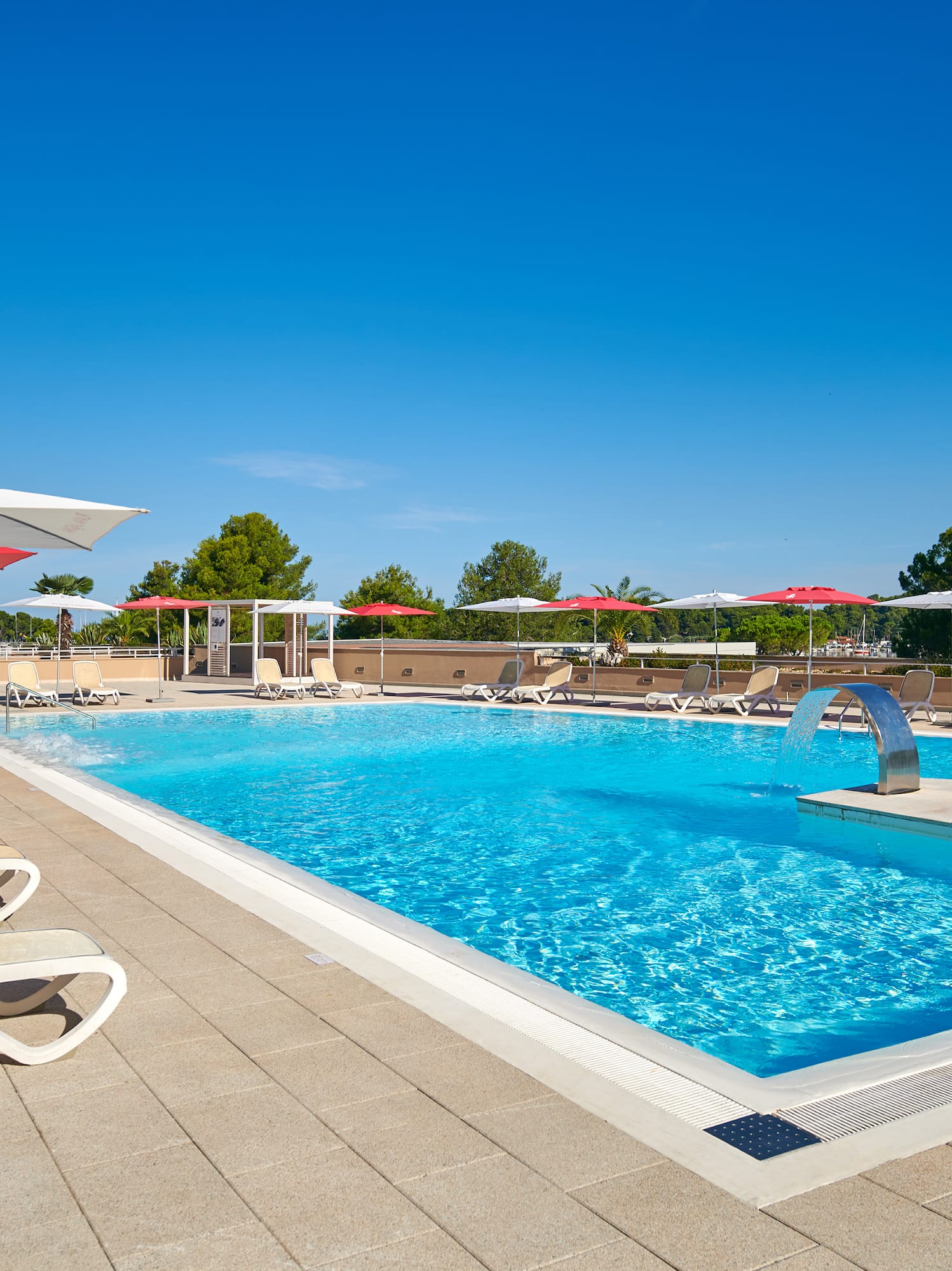 a pool with umbrellas and chairs