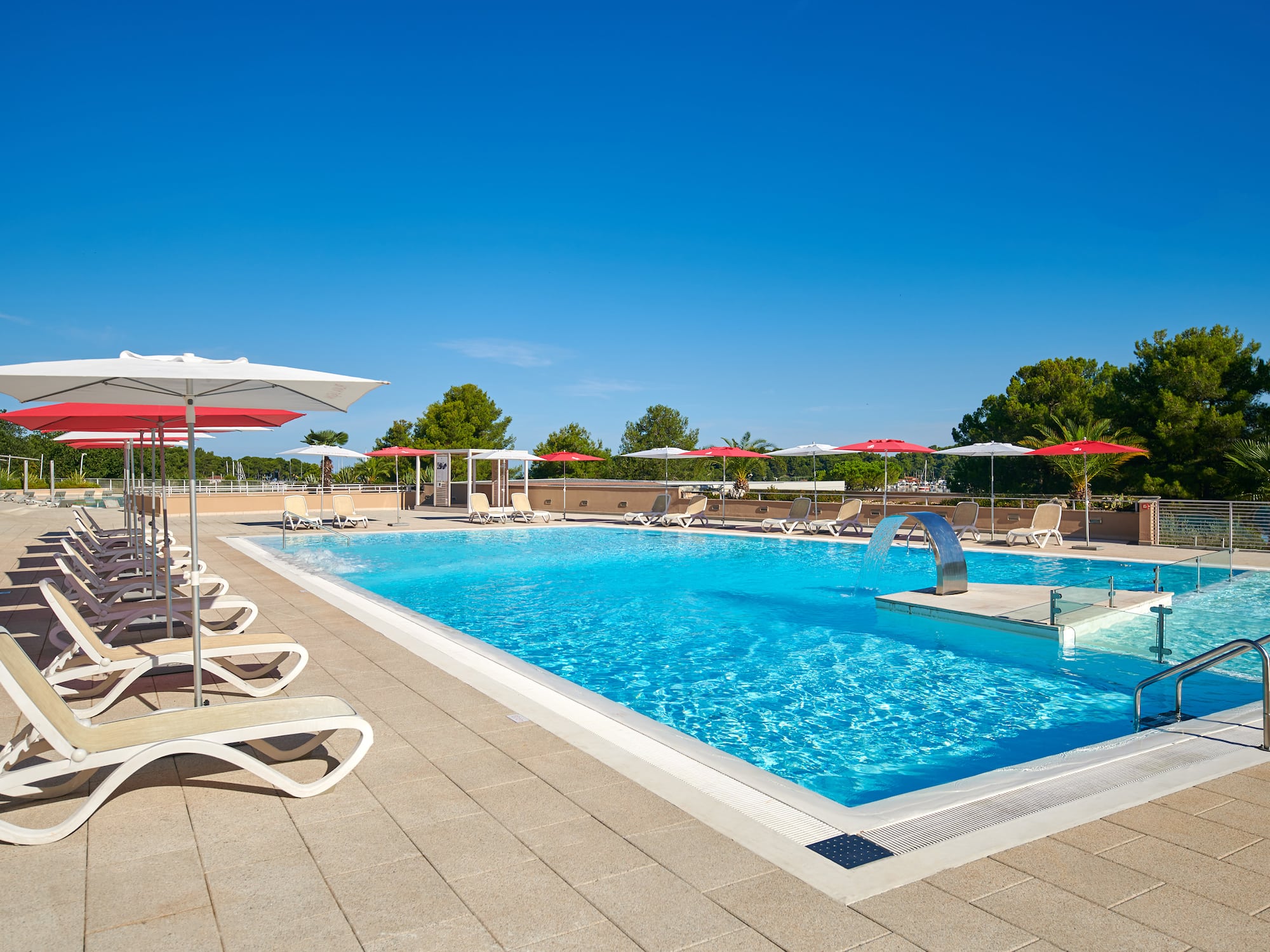 a pool with umbrellas and chairs