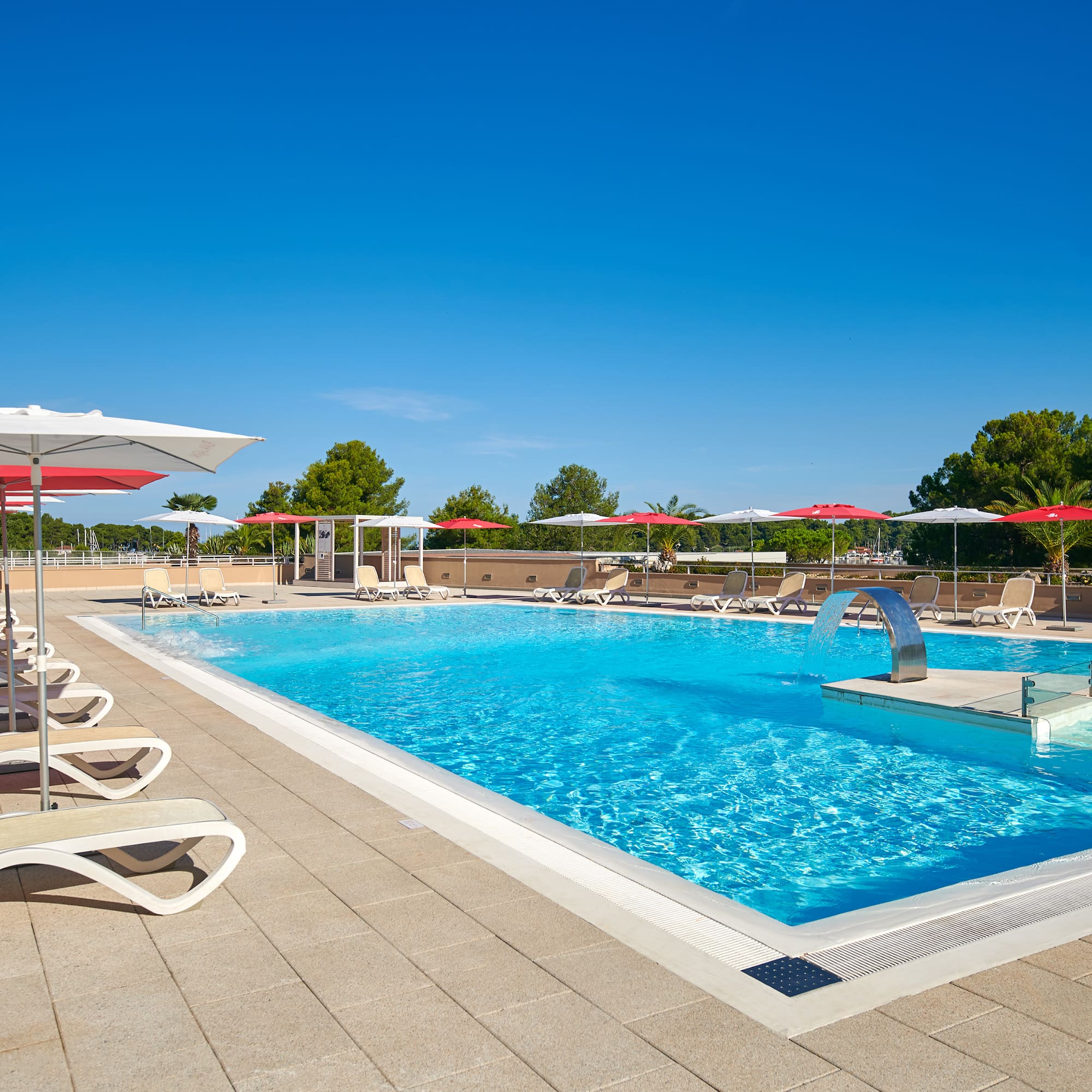 a pool with umbrellas and chairs