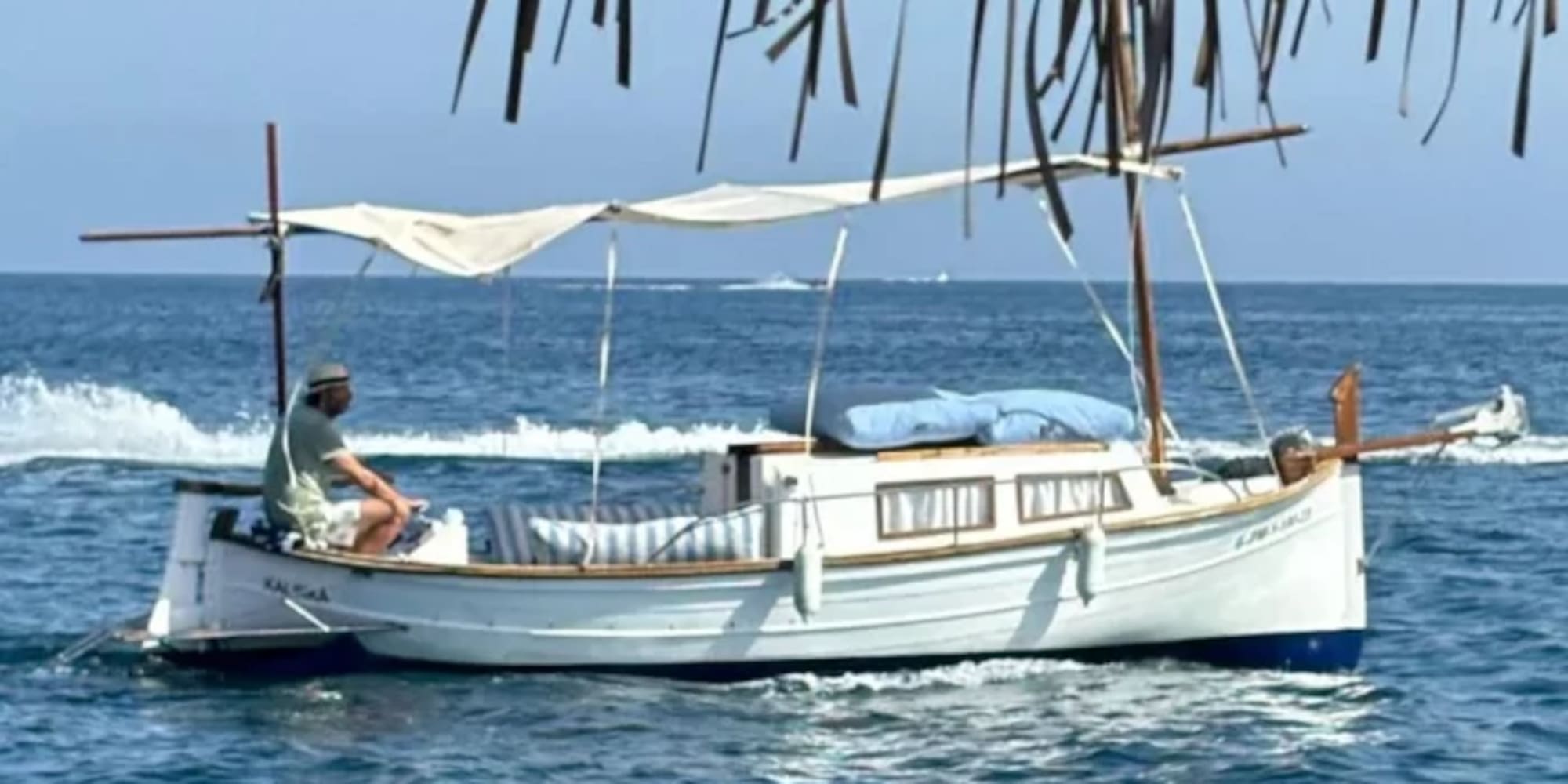 a man sitting on a boat in the water