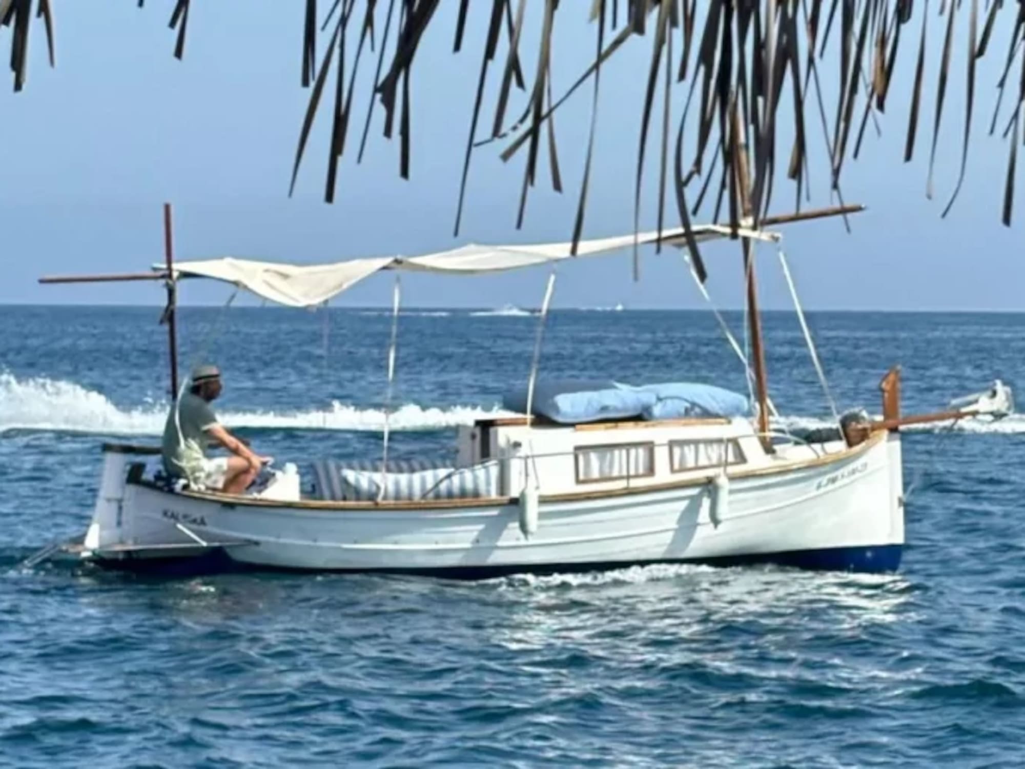a man sitting on a boat in the water