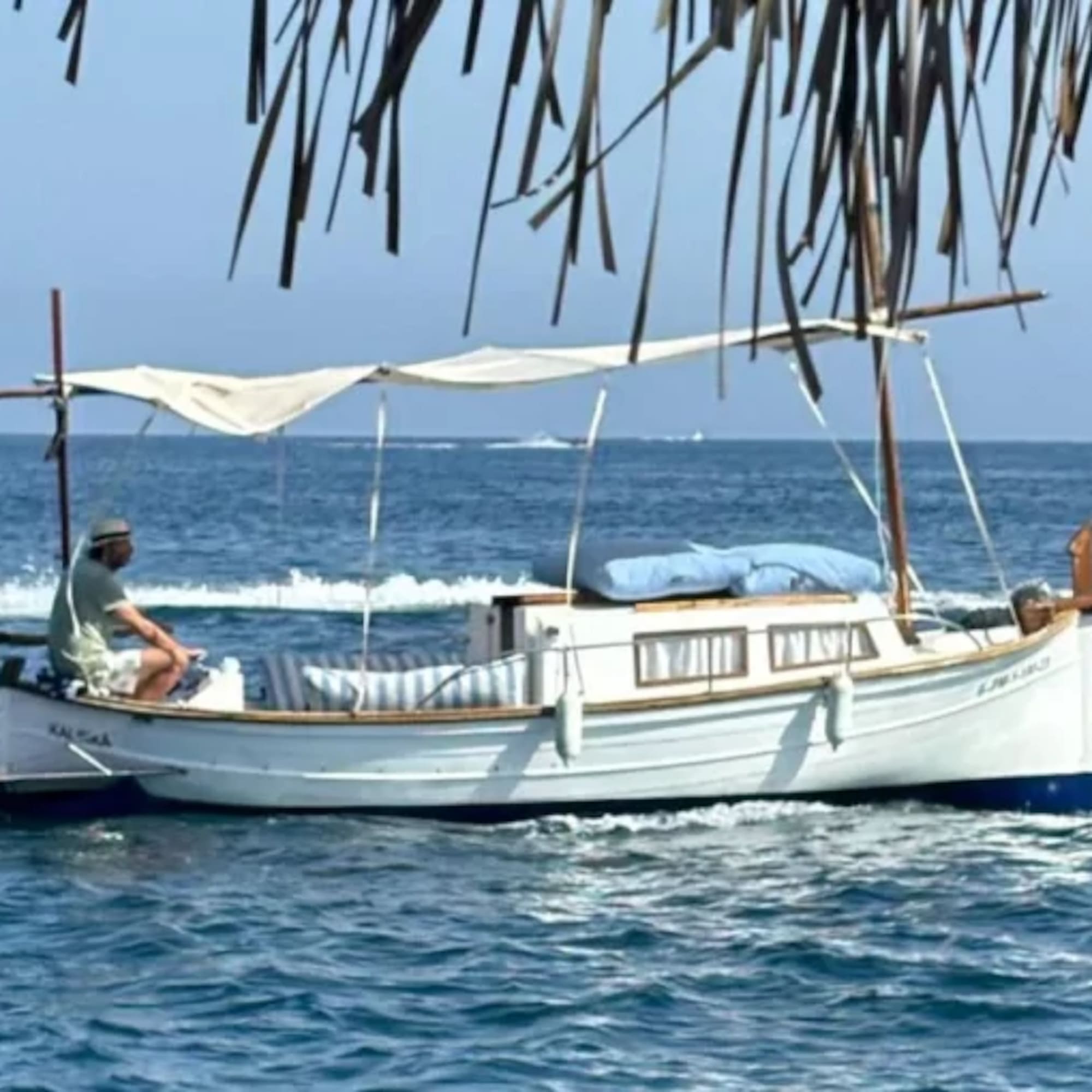 a man sitting on a boat in the water