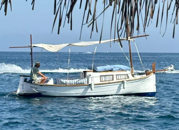 a man sitting on a boat in the water