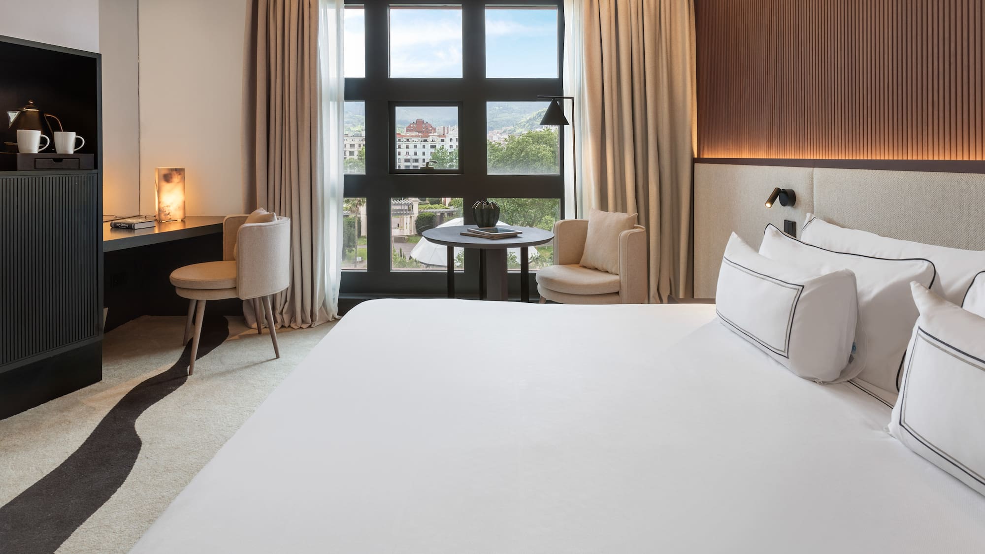 a room with a bed and a table and chairs