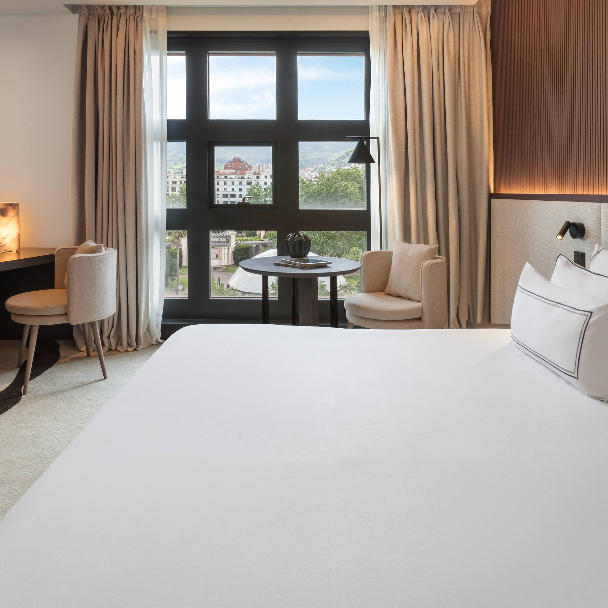 a room with a bed and a table and chairs