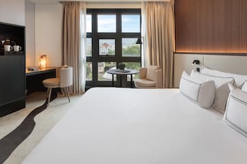 a room with a bed and a table and chairs