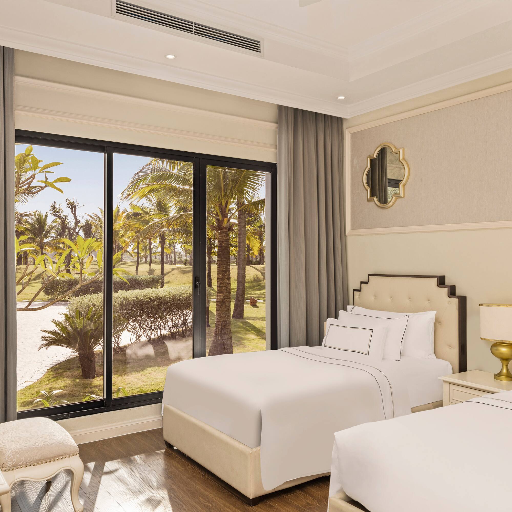 a bedroom with two beds and a large window