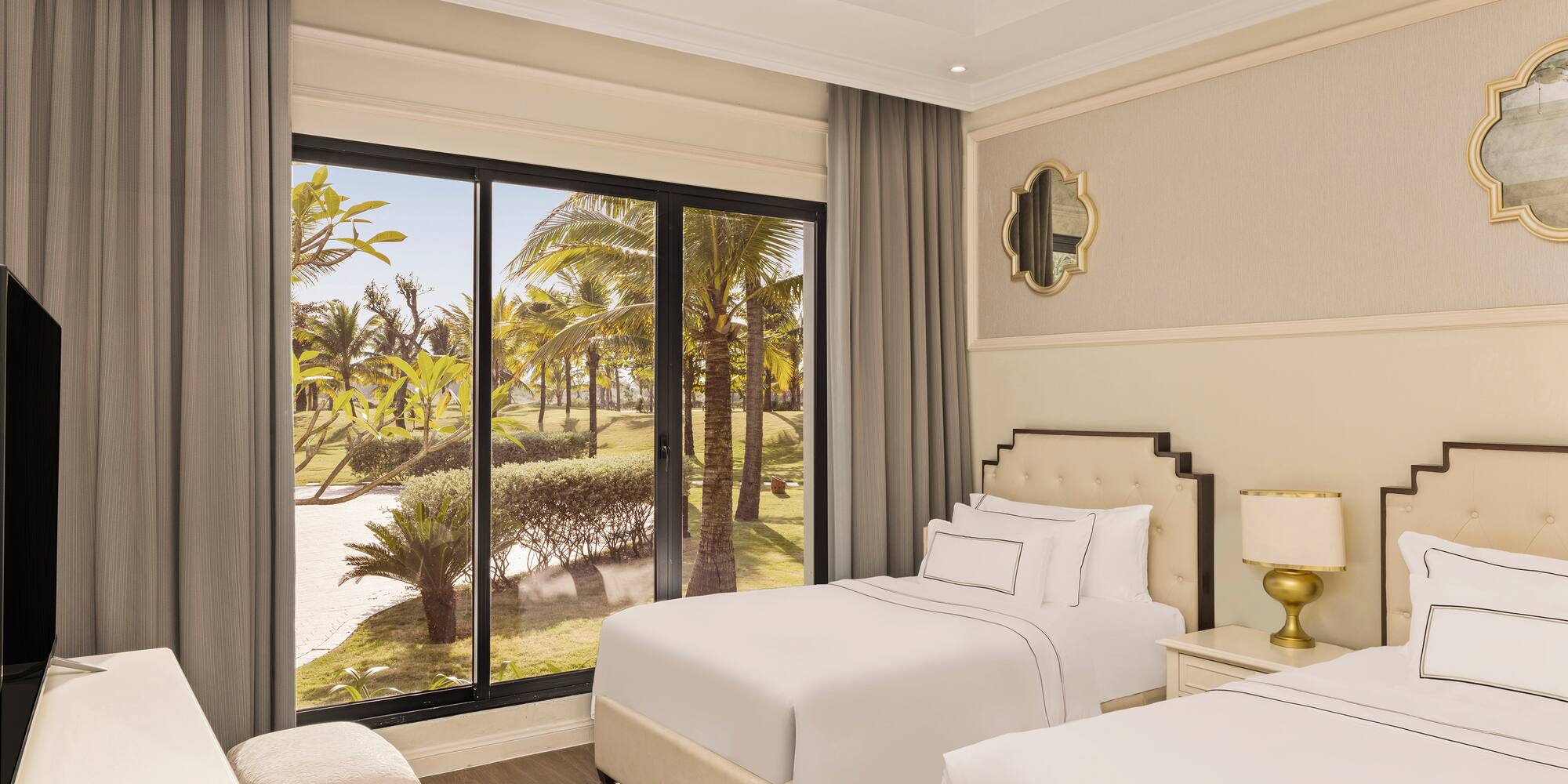 a bedroom with two beds and a large window