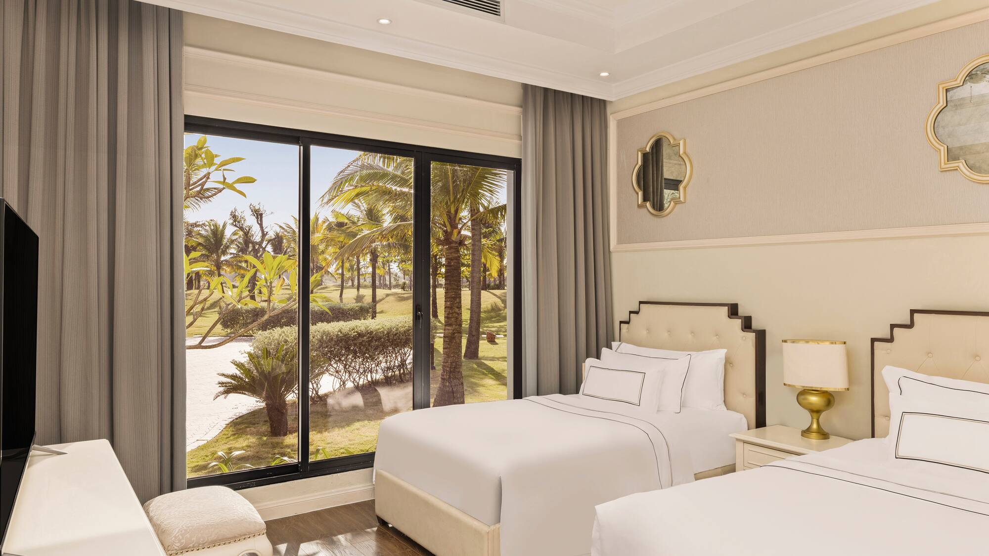 a bedroom with two beds and a large window