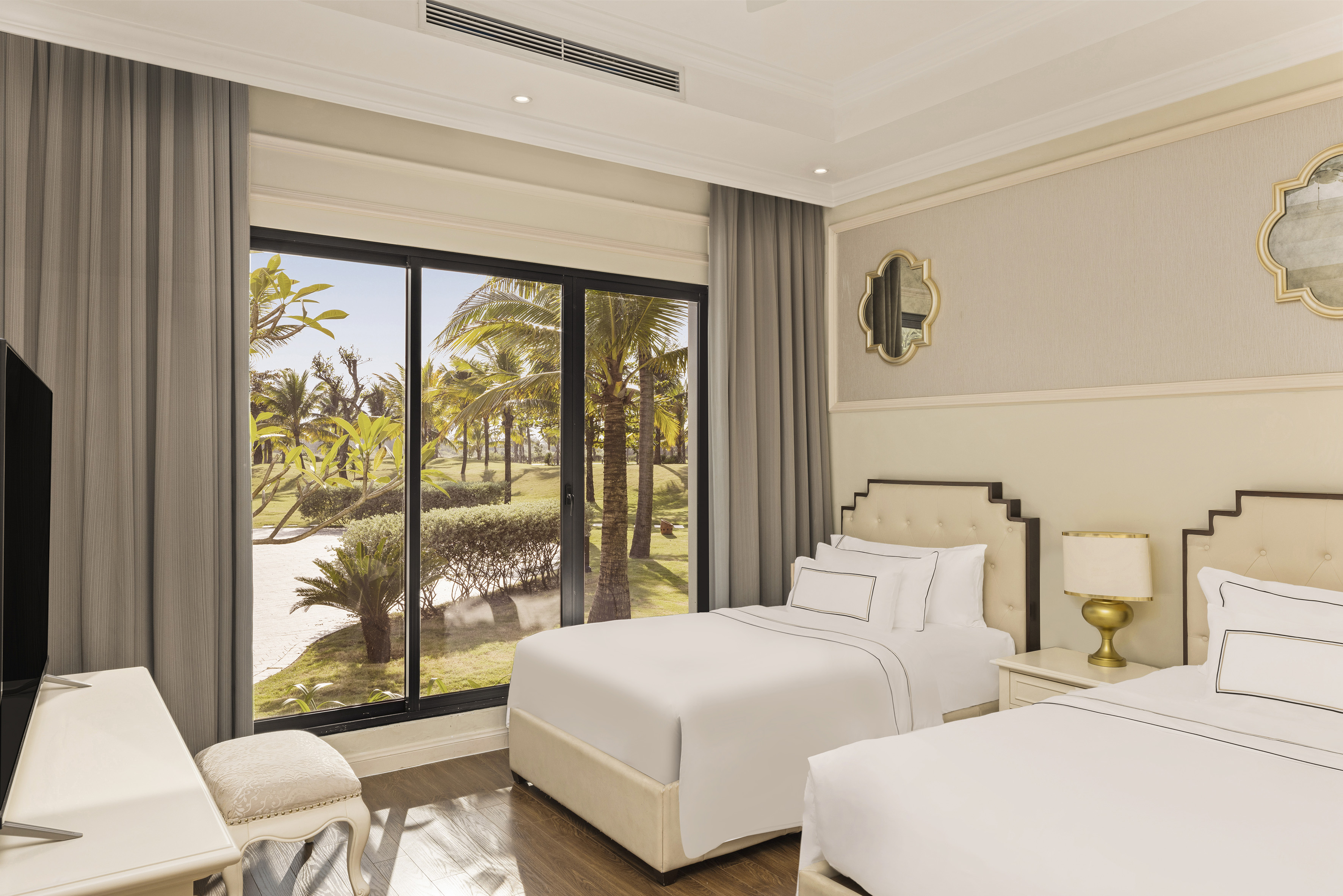 a bedroom with two beds and a large window