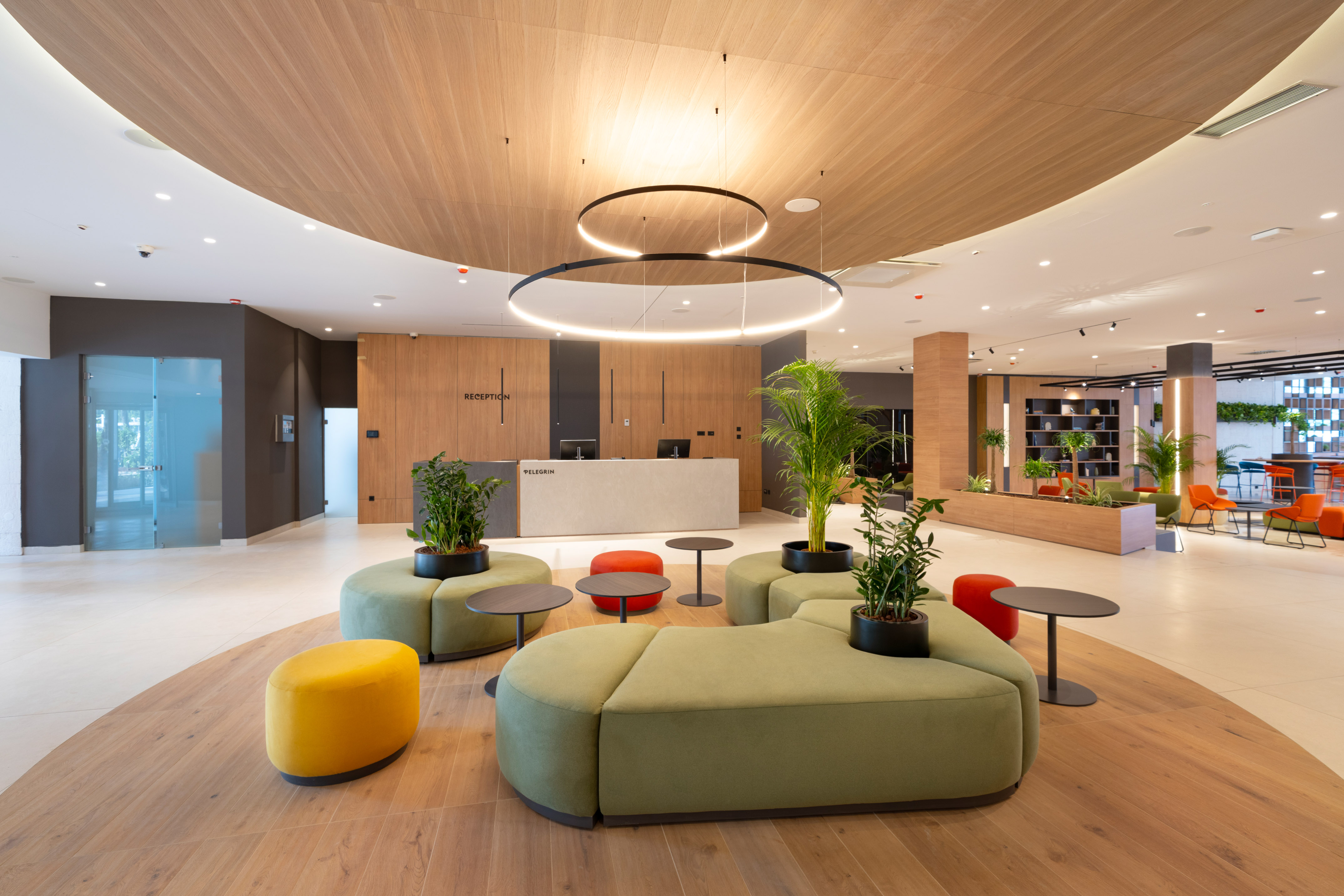 a lobby with a large round table and chairs