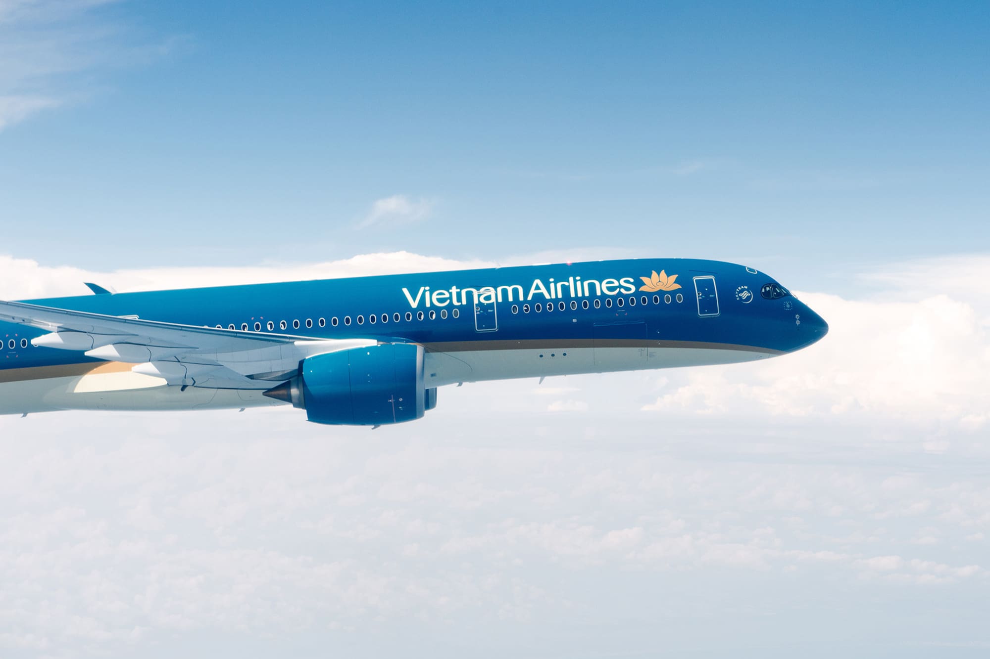 a blue airplane in the air