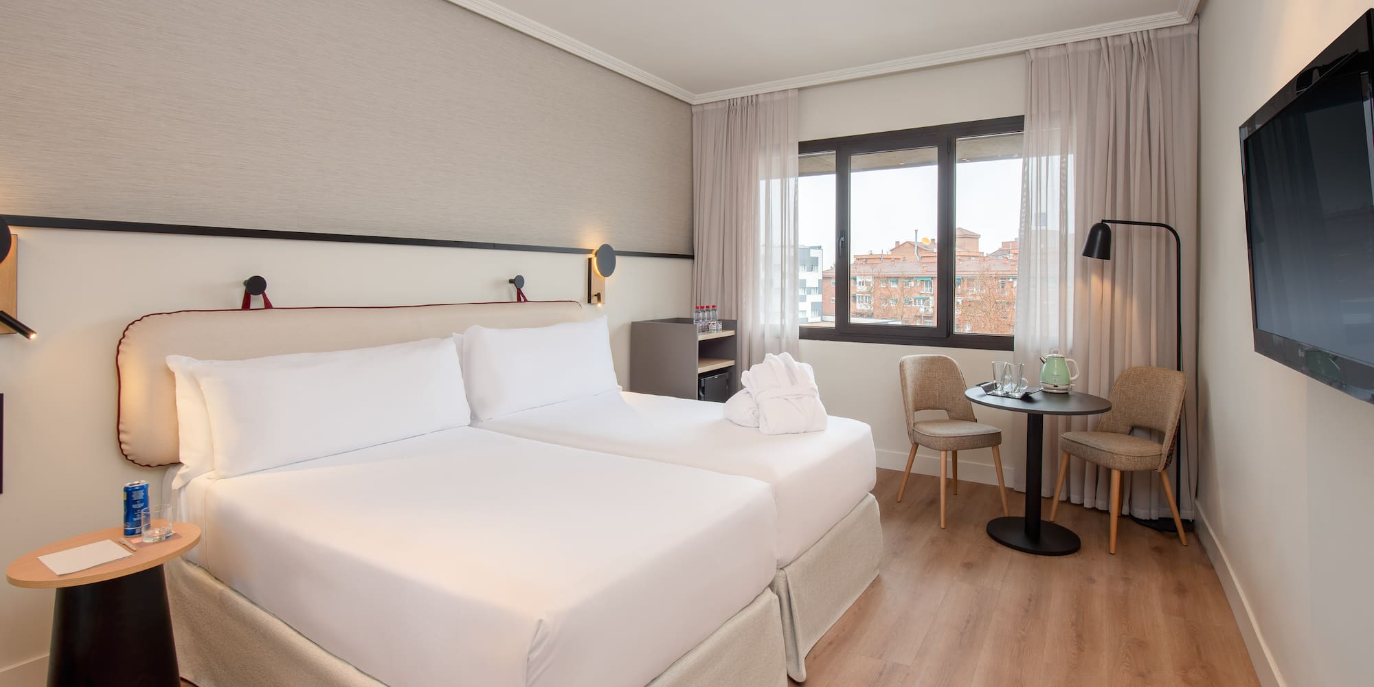 a room with two beds and a table