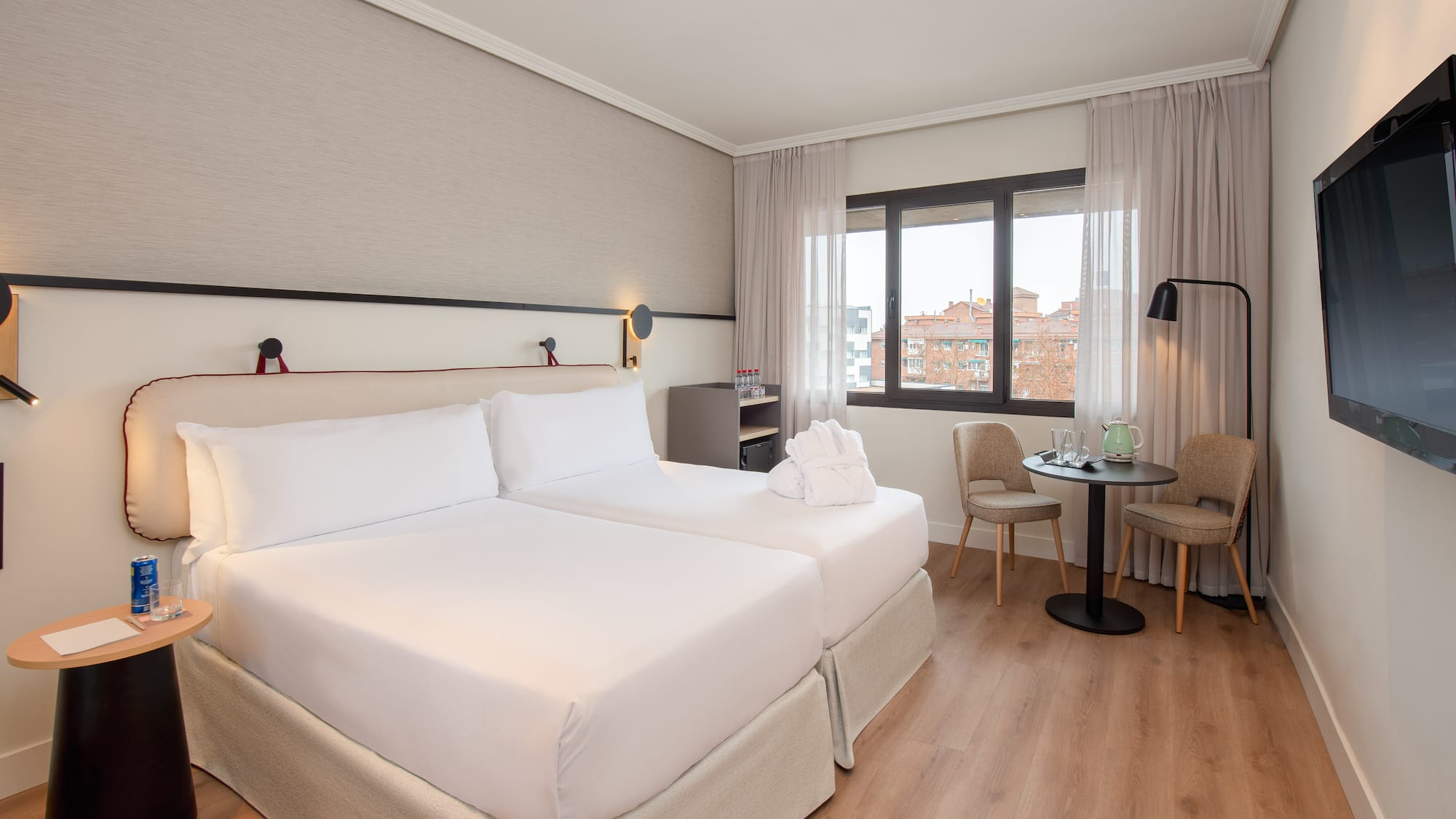 a room with two beds and a table