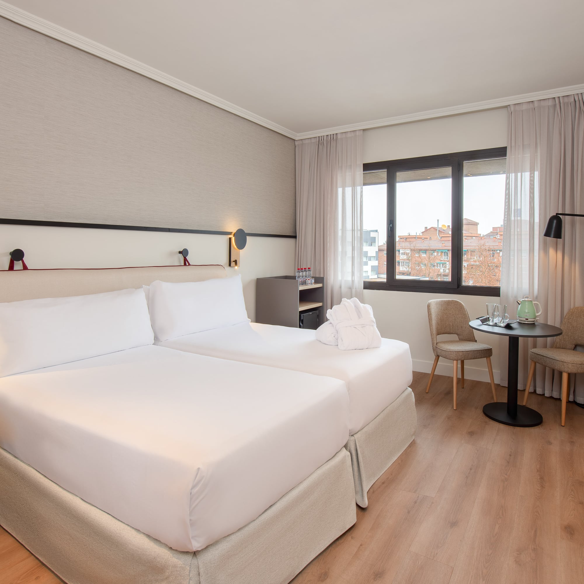 a room with two beds and a table