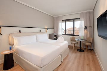 a room with two beds and a table