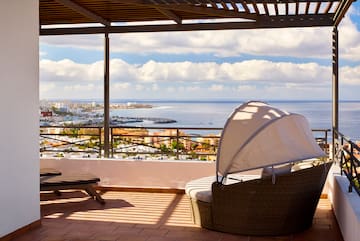 a chair and a chair on a patio overlooking a city