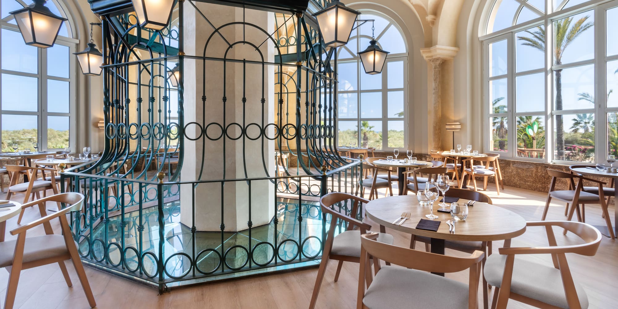 a room with tables and chairs and a metal cage