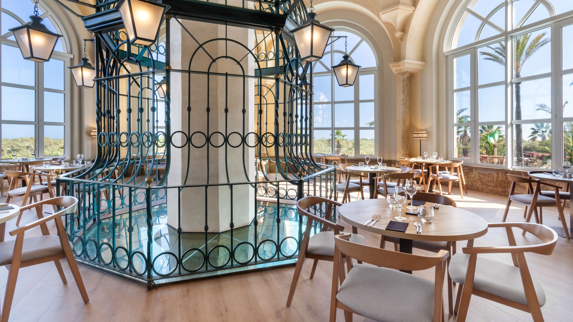 a room with tables and chairs and a metal cage