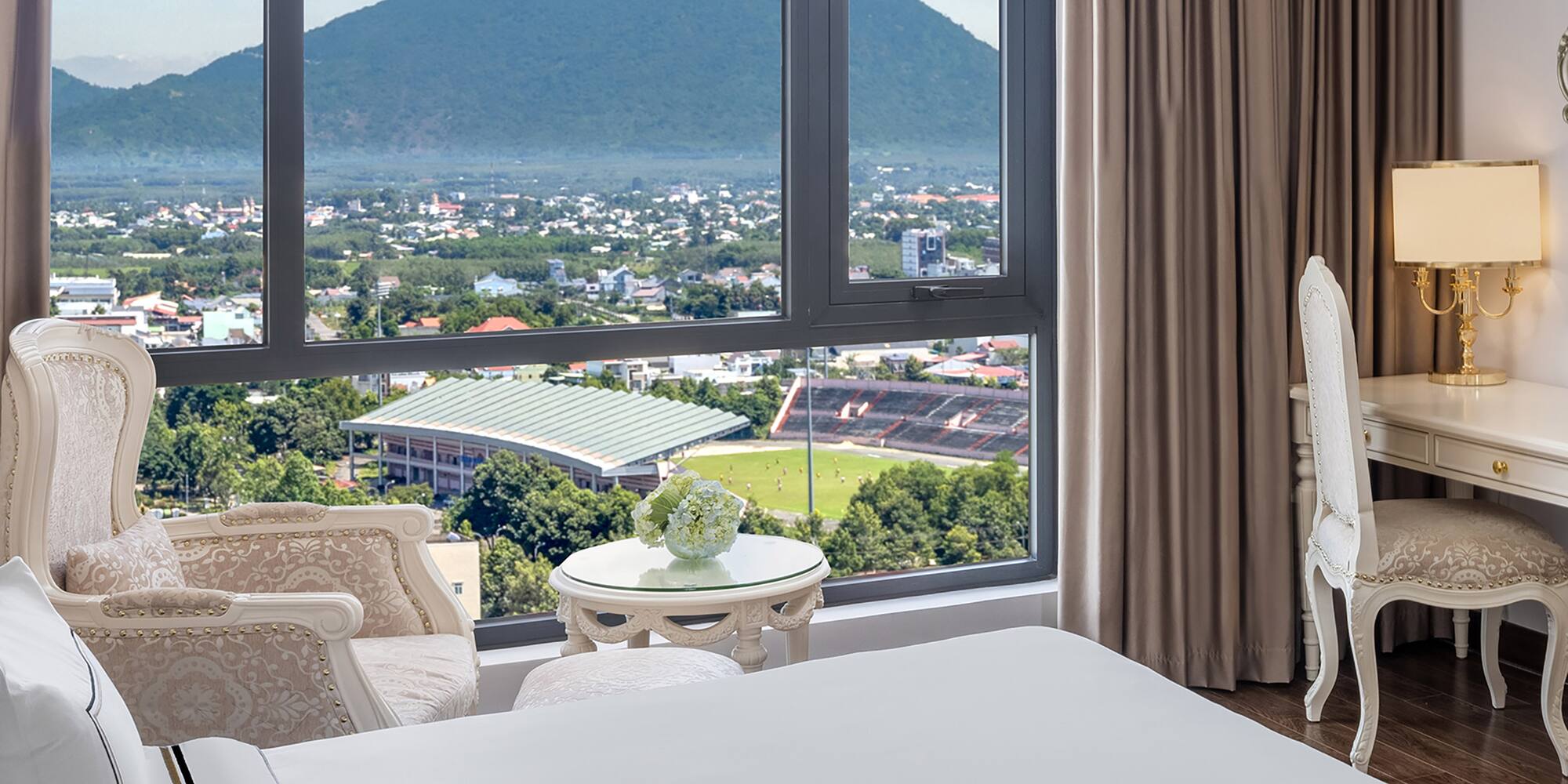 a room with a large window and a view of a mountain