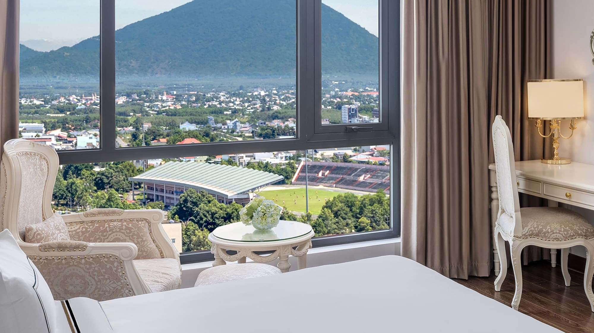 a room with a large window and a view of a mountain