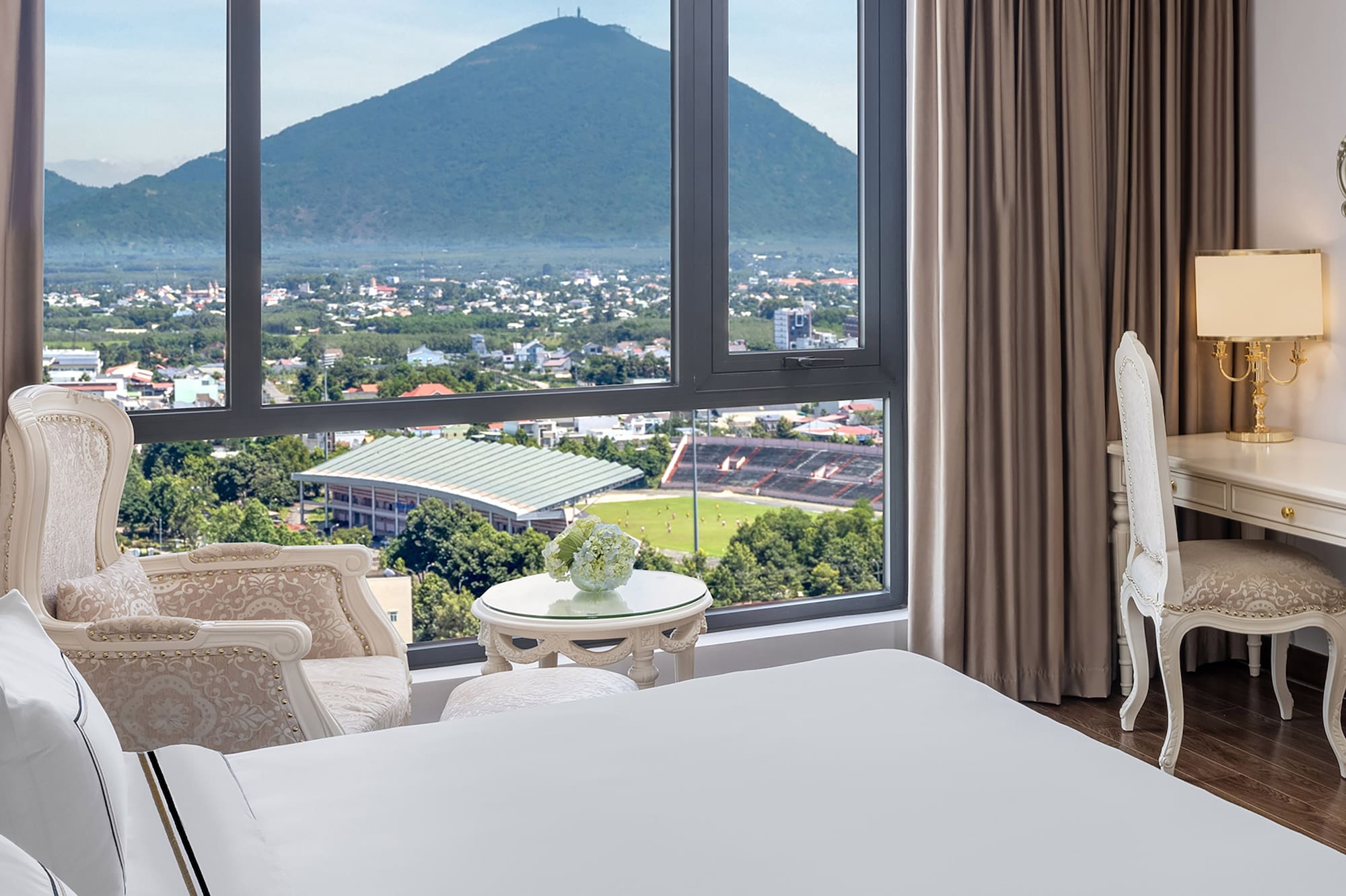 a room with a large window and a view of a mountain