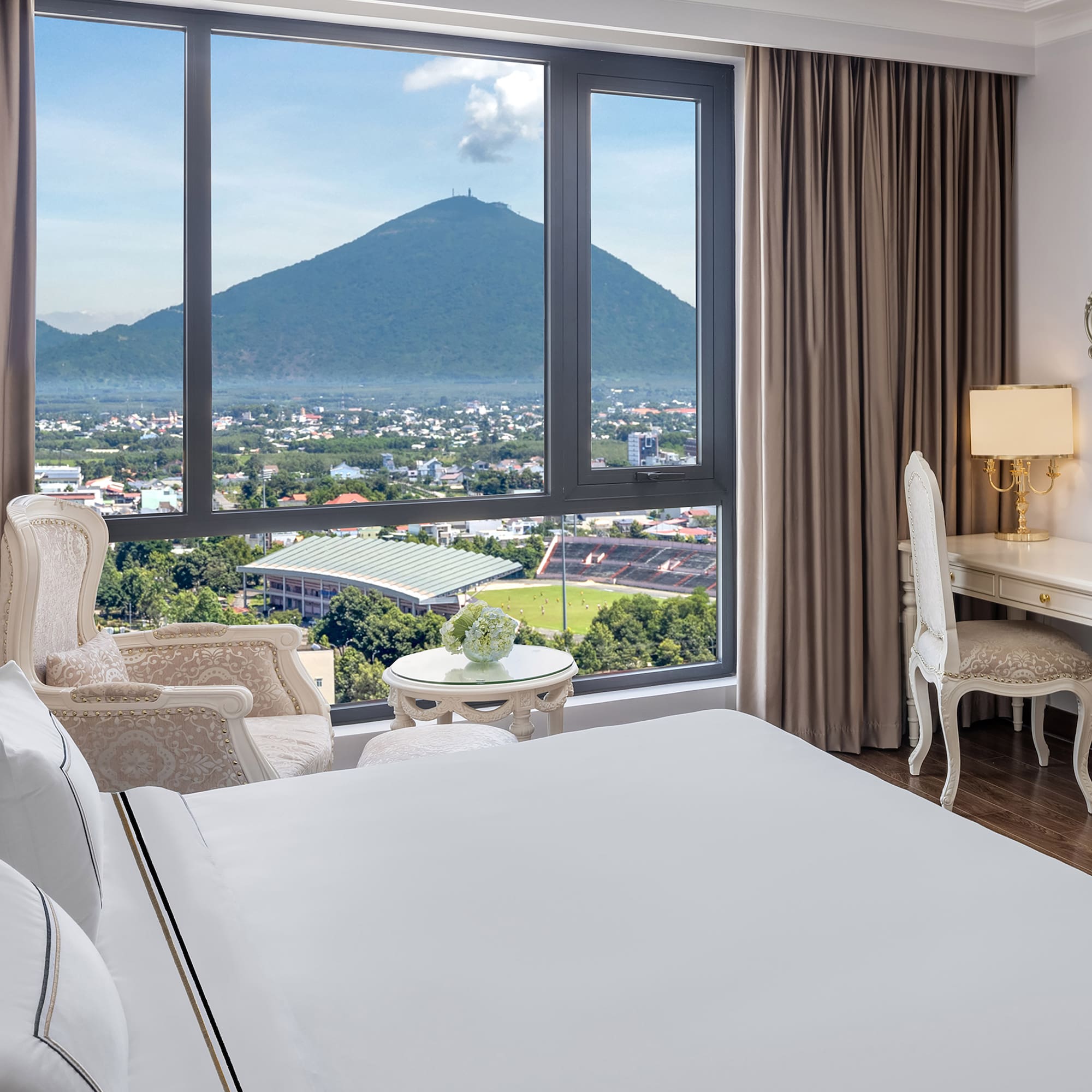 a room with a large window and a view of a mountain