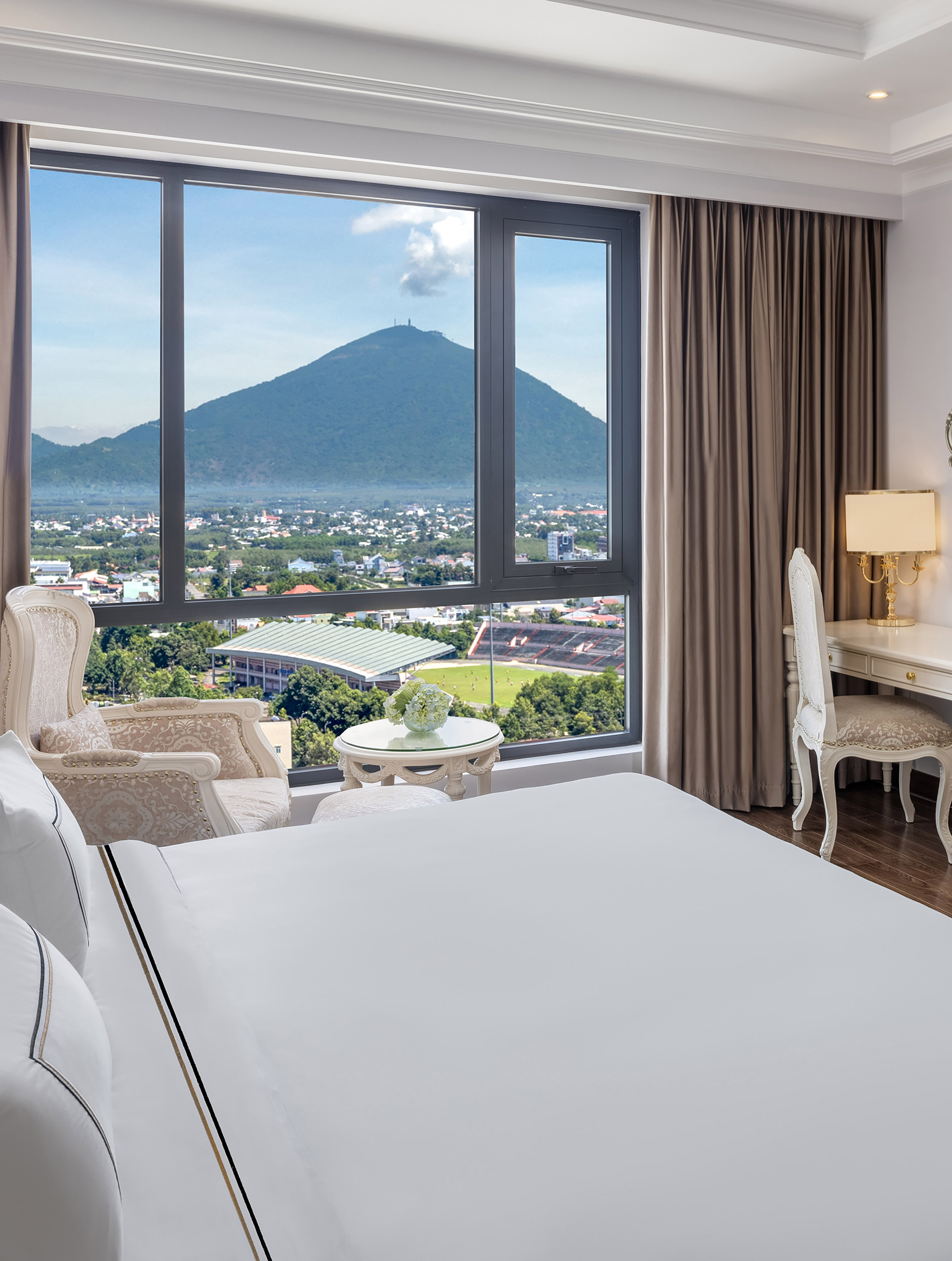 a room with a large window and a view of a mountain