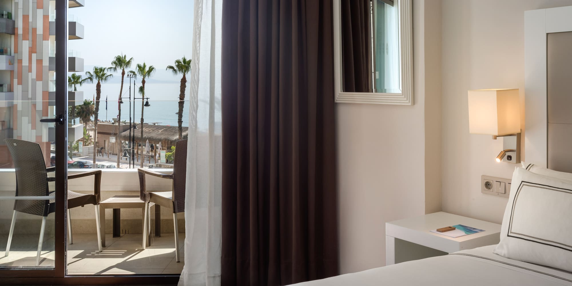 a room with a window and a view of the ocean