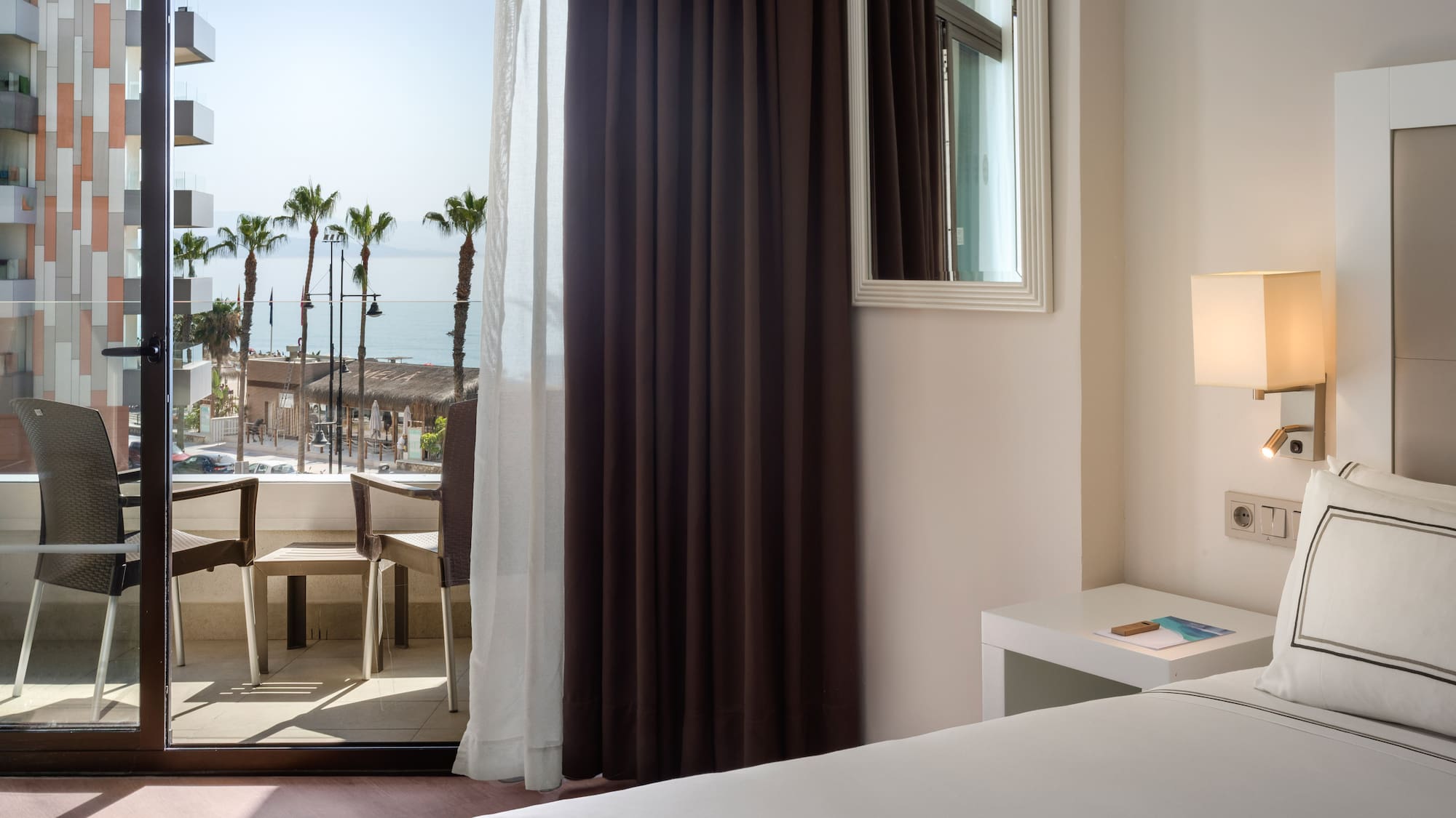 a room with a window and a view of the ocean