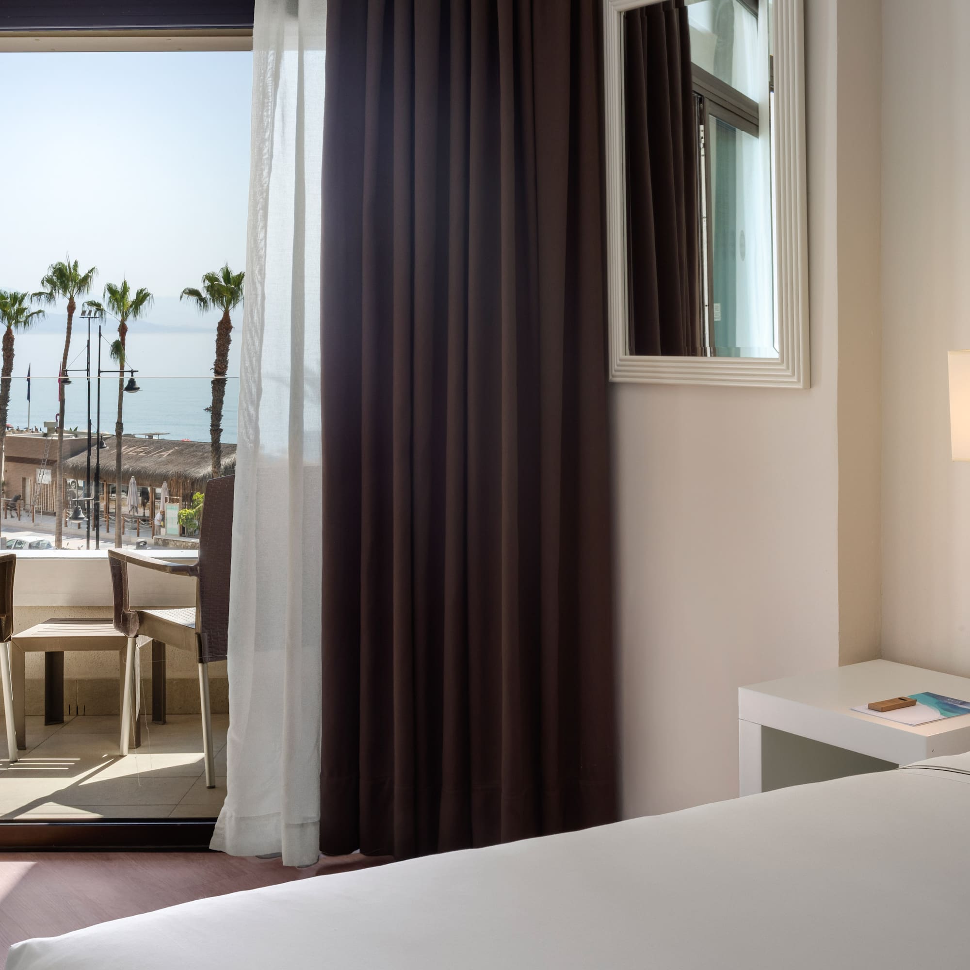 a room with a window and a view of the ocean