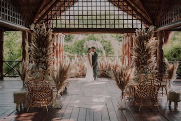 a man and woman kissing under a gazebo