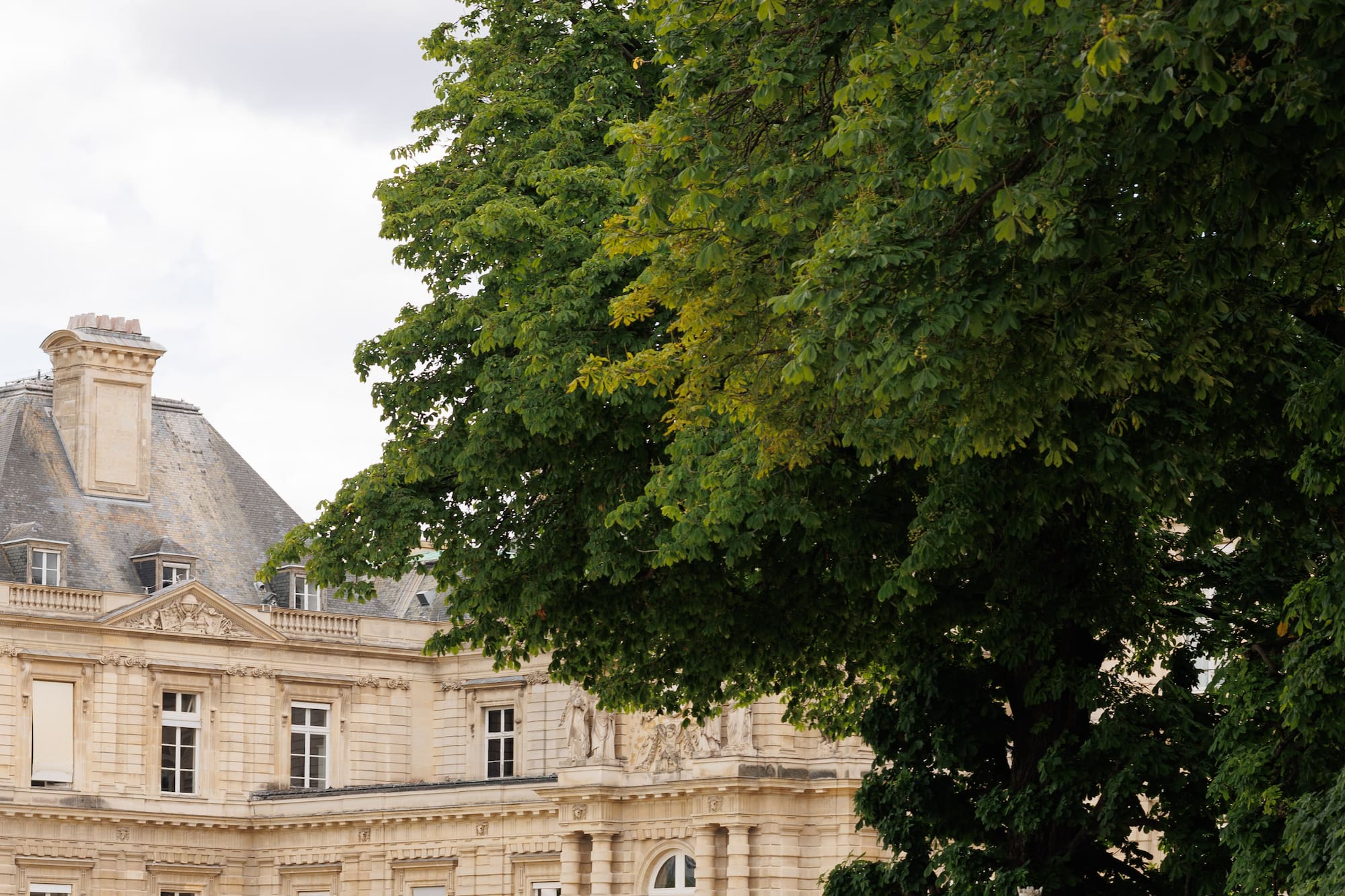 a woman sitting in a chair in front of a large building