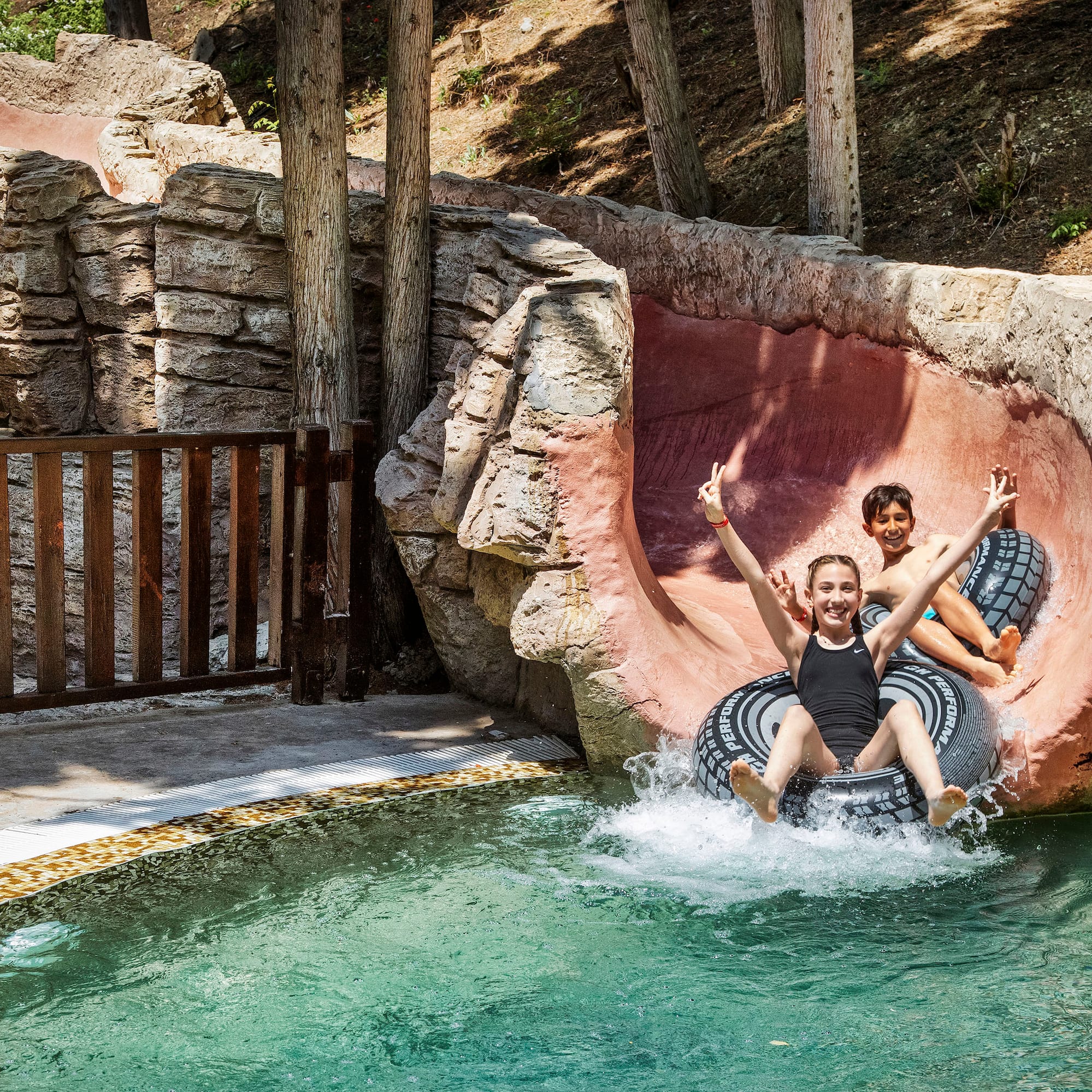 two girls on a tube in a pool