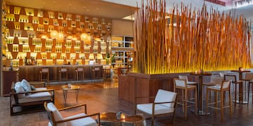 a room with a bar and chairs