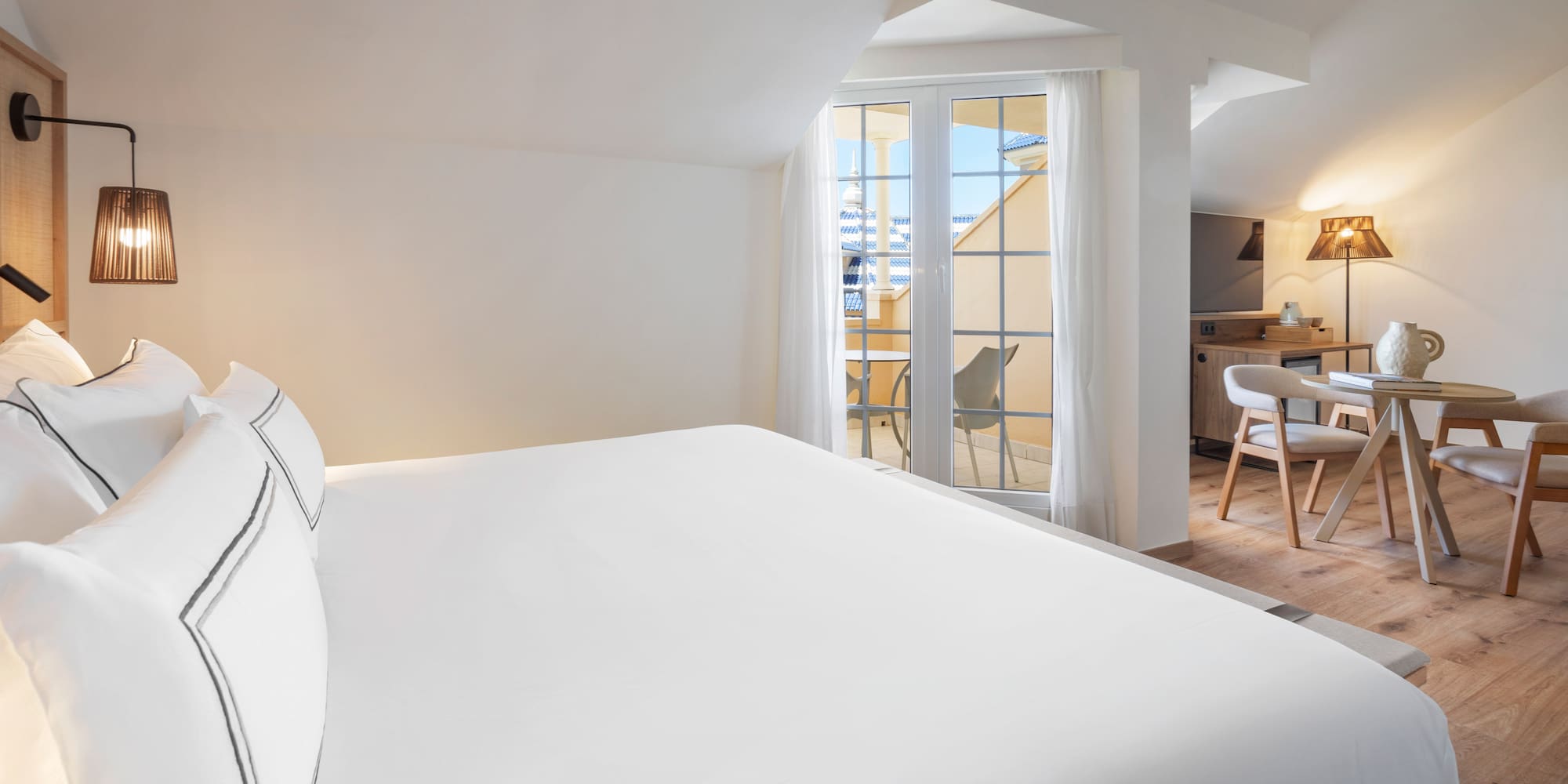 a bed in a room with a kitchen and dining area