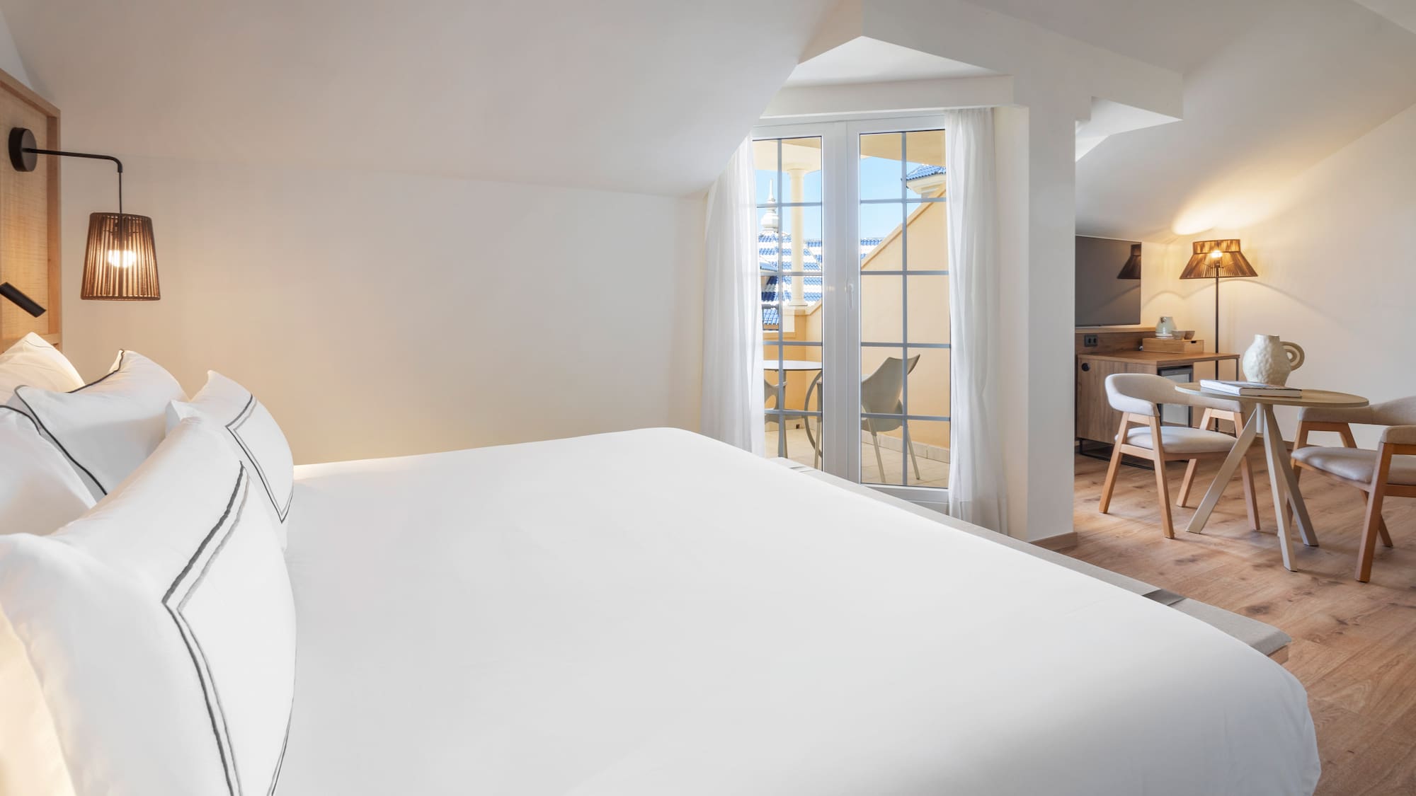 a bed in a room with a kitchen and dining area