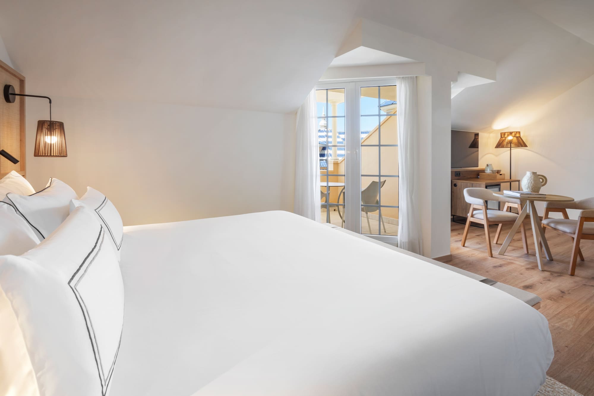 a bed in a room with a kitchen and dining area