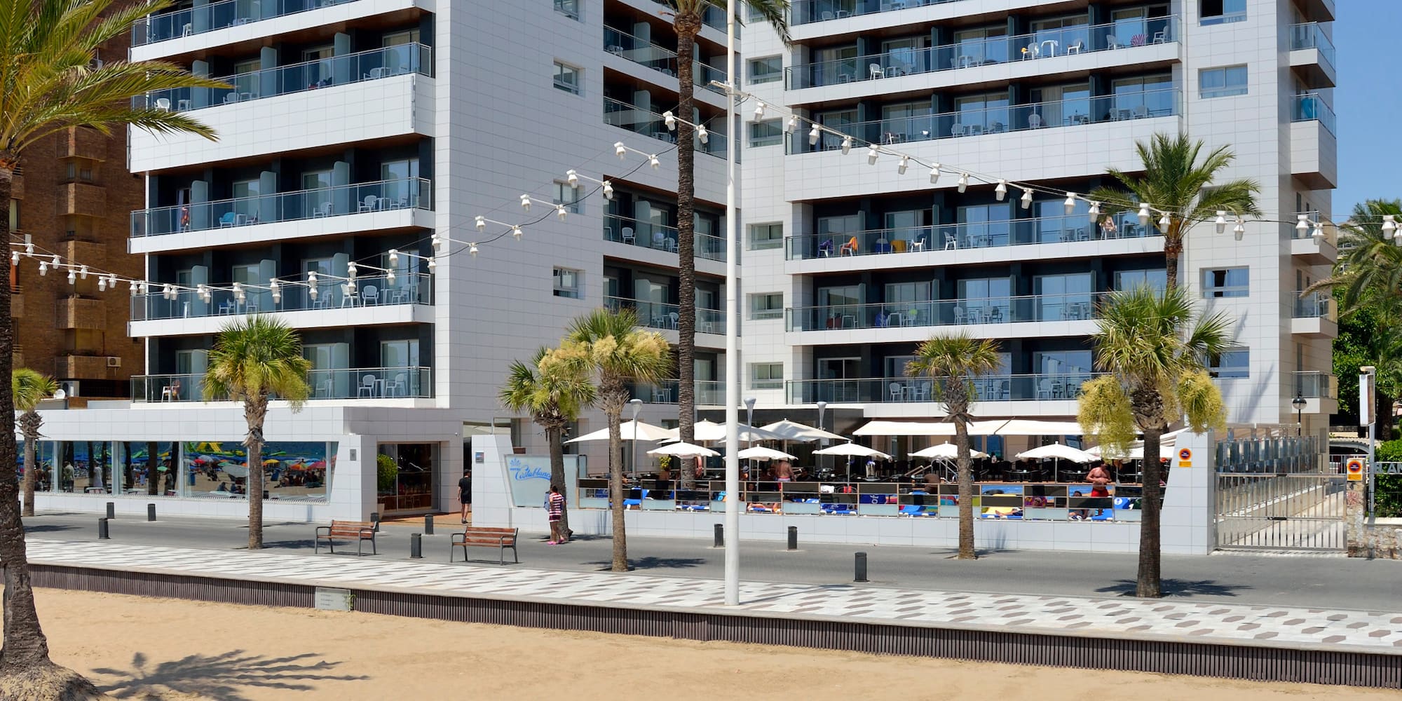 a building with palm trees and a beach