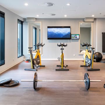 a room with exercise bikes and weights