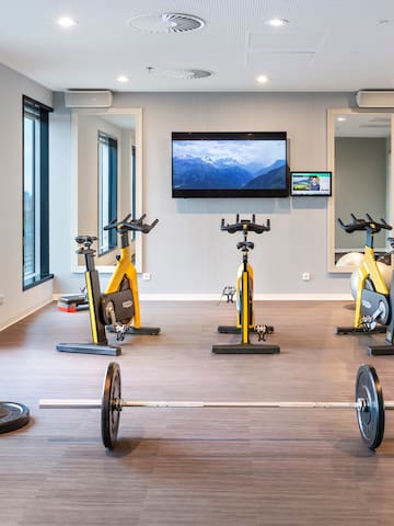 a room with exercise bikes and weights
