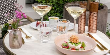 a table with glasses and food on it