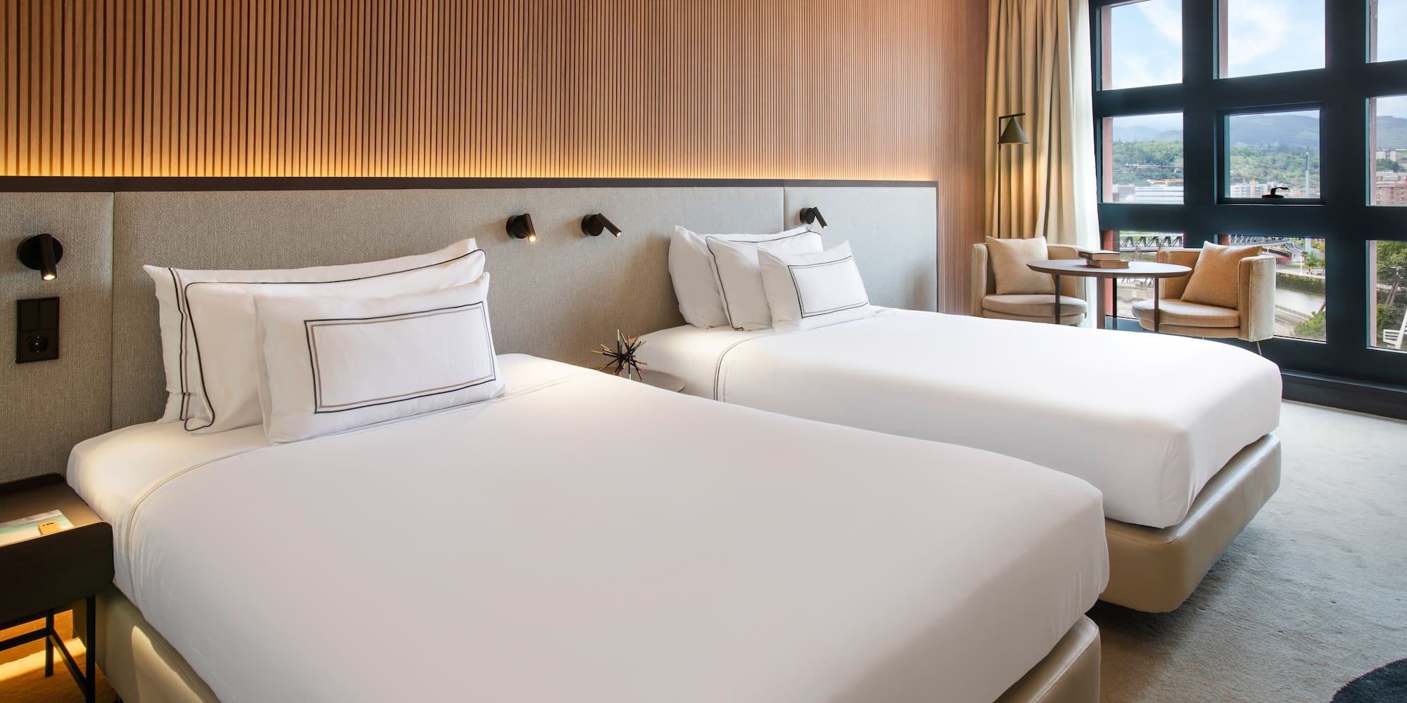 a room with two beds and a table