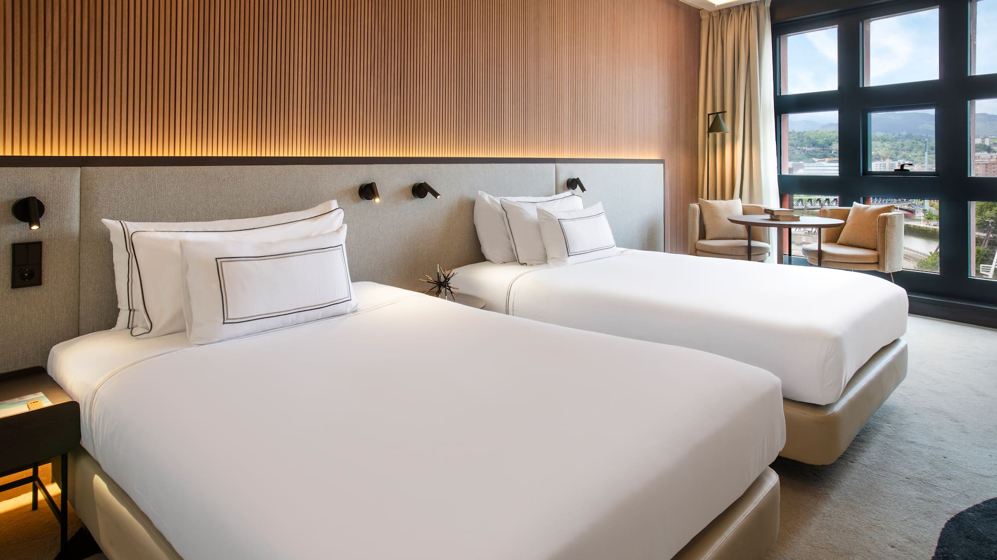 a room with two beds and a table