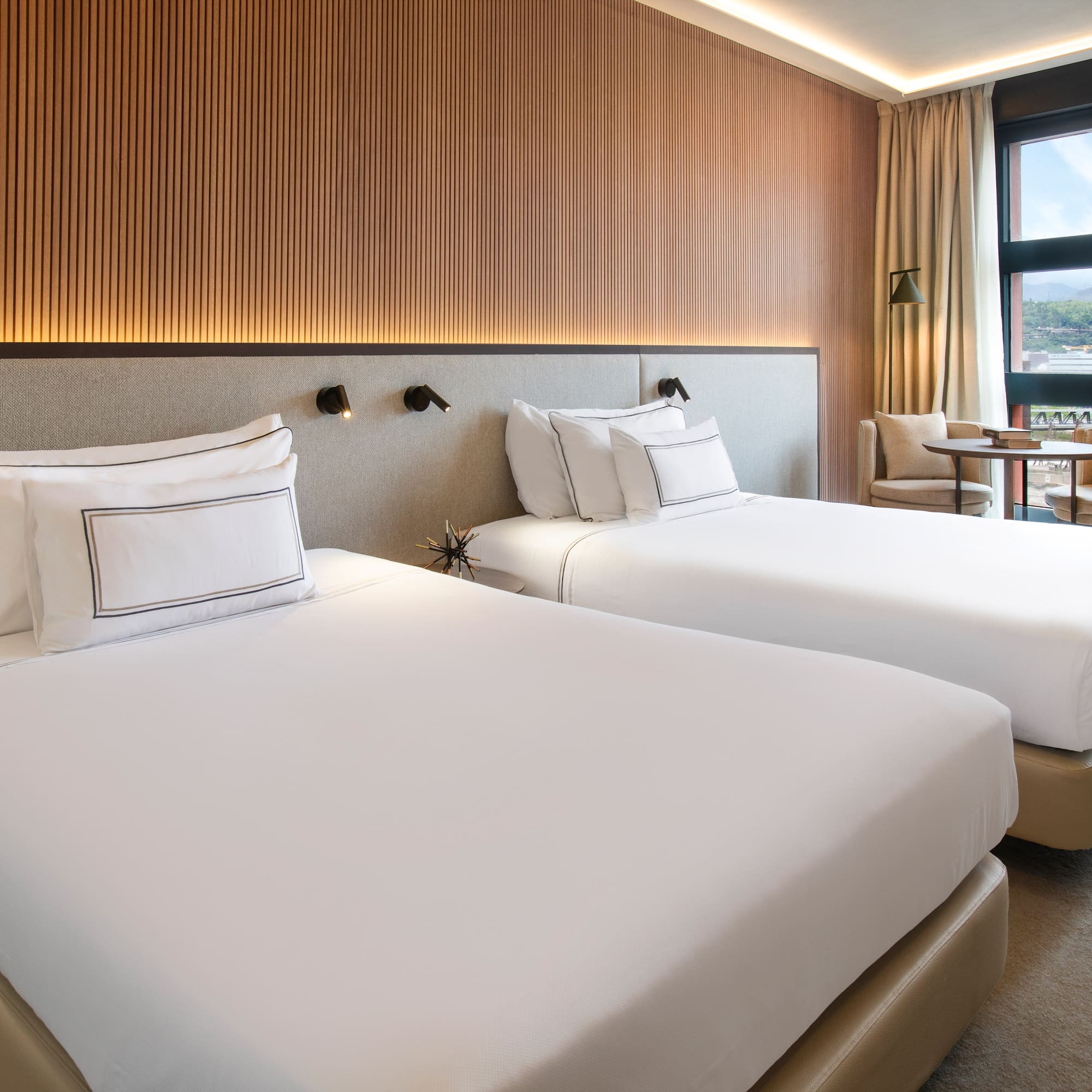 a room with two beds and a table