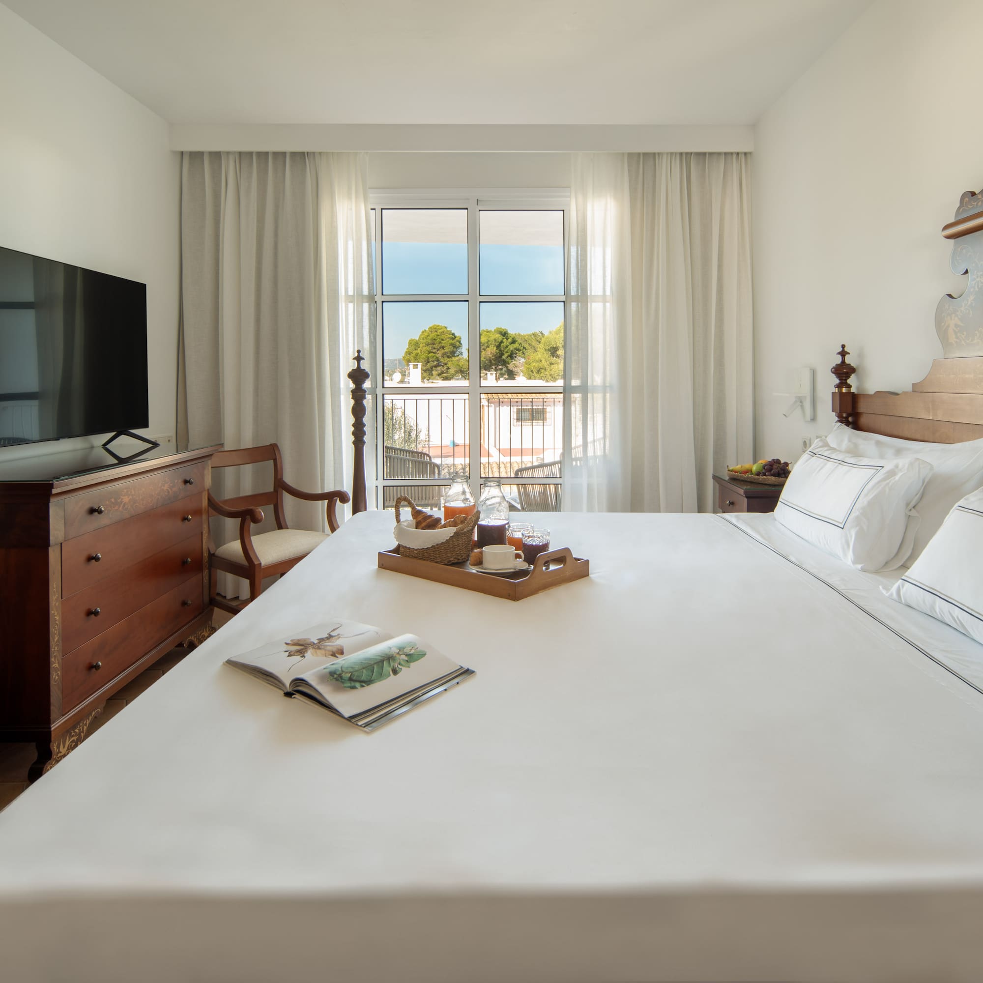 a bed with a tray of food on it