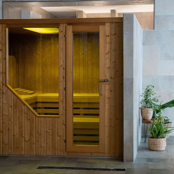 a wooden sauna door with glass doors